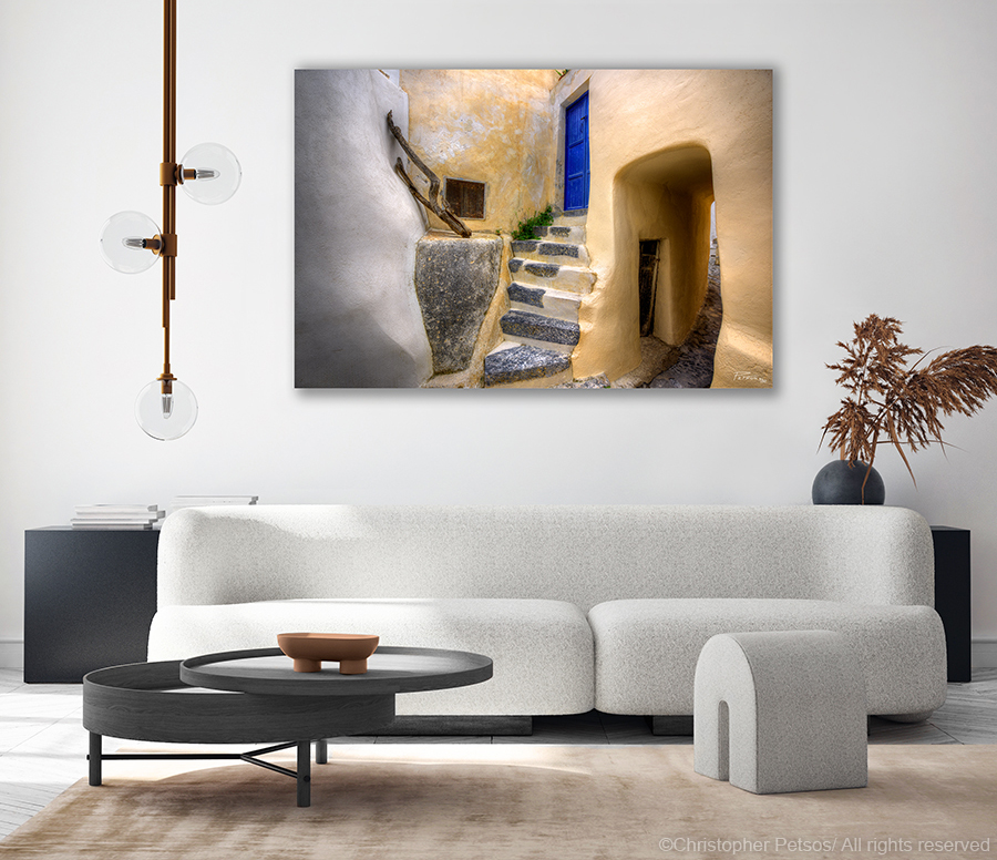 yellow architecture with blue door and arched passageway in Santorini